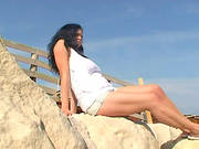 Enchanting Brunette Solo Model With Long Hair In A Sexy Short Posing Seductively Outdoor